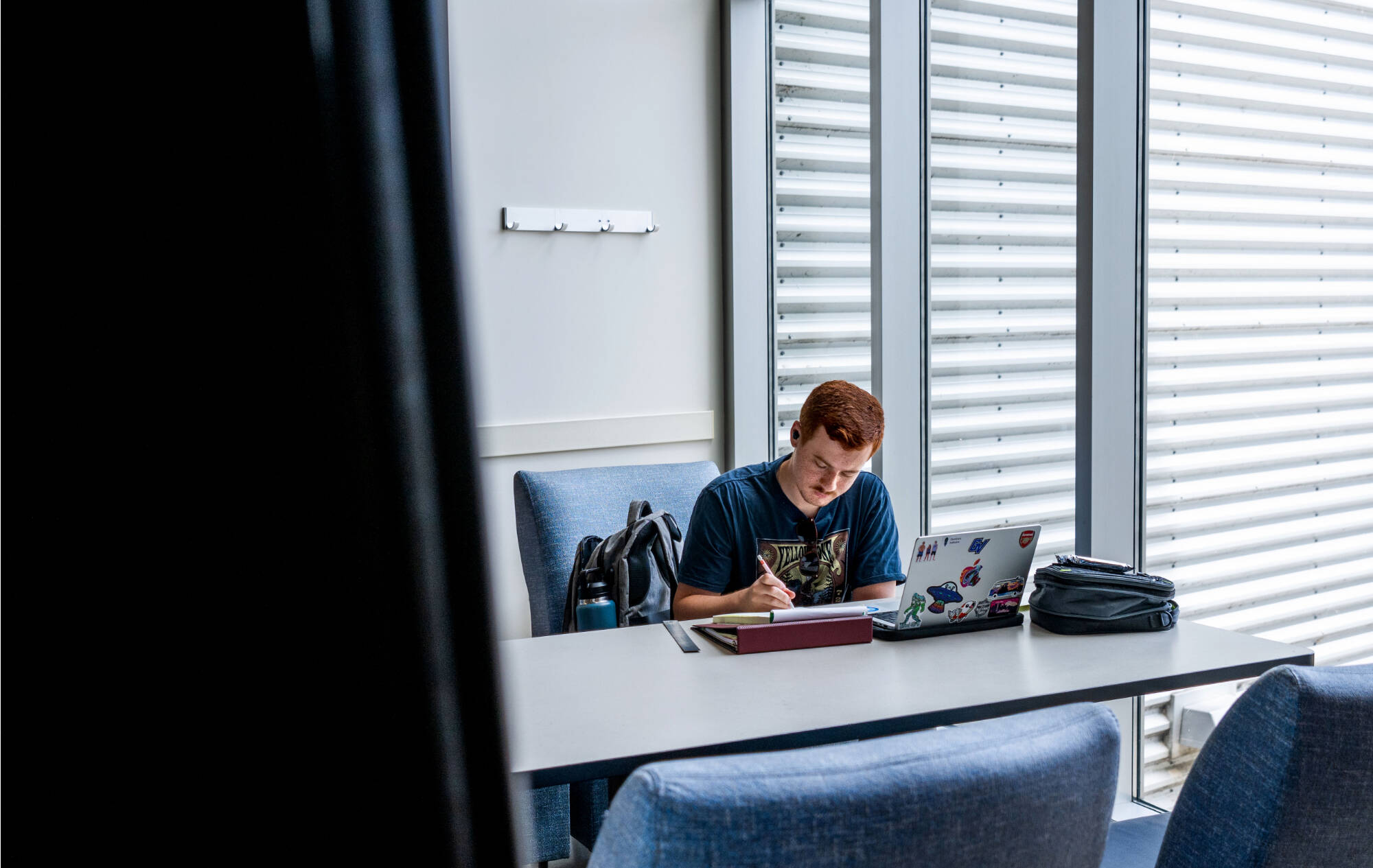 Dominick Kafkakis, a senior mechanical engineering student, works on homework for his Introduction to Finite Element Analysis (EGR 329) class while studying in Kennedy Hall of Engineering on the City Campus June 4.